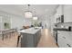 Spacious kitchen featuring an island, modern appliances, and seamless transition to the living and dining areas at 627 Georgias Landing Pkwy, Raleigh, NC 27603