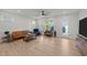 Bright living room with wood floors, ample natural light, and modern ceiling fan at 627 Georgias Landing Pkwy, Raleigh, NC 27603