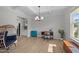 Bright living room with coffered ceilings, modern chandelier, and wood-look floors at 627 Georgias Landing Pkwy, Raleigh, NC 27603