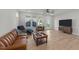 Spacious living room with wood floors, ample natural light, and modern ceiling fan at 627 Georgias Landing Pkwy, Raleigh, NC 27603