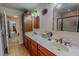 Bright bathroom with double sinks, wood cabinets, and a glass-enclosed shower at 6305 Holly Ridge Rd, Rougemont, NC 27572