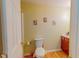 Neutral colored bathroom with wood look floors and wood vanity at 6305 Holly Ridge Rd, Rougemont, NC 27572