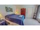 Bedroom with ample storage, neutral carpet, and great natural light from a nearby window at 6305 Holly Ridge Rd, Rougemont, NC 27572