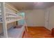 Bedroom with a bunk bed, ceiling fan, hardwood floors and neutral colored walls at 6305 Holly Ridge Rd, Rougemont, NC 27572