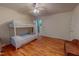 Bright bedroom features a bunk bed, ceiling fan, hardwood floors and natural light at 6305 Holly Ridge Rd, Rougemont, NC 27572