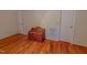 Corner bedroom offers hardwood floors, wooden storage chest, and multiple closets at 6305 Holly Ridge Rd, Rougemont, NC 27572
