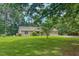 Charming brick home with a well-maintained lawn, mature trees, and an attached two-car garage at 6305 Holly Ridge Rd, Rougemont, NC 27572