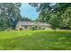 Charming brick home with mature trees, lush green lawn, and a three-car attached garage at 6305 Holly Ridge Rd, Rougemont, NC 27572