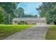 Attractive brick home with three-car garage, mature landscaping, and a long driveway at 6305 Holly Ridge Rd, Rougemont, NC 27572