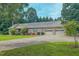Brick home featuring a two-car attached garage, well-kept lawn, and colorful bushes at 6305 Holly Ridge Rd, Rougemont, NC 27572