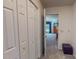 Hallway with closed closet and doorway looking into bedroom with neutral carpeting at 6305 Holly Ridge Rd, Rougemont, NC 27572