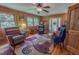 Comfortable living room with natural light, three armchairs, and unique rug at 6305 Holly Ridge Rd, Rougemont, NC 27572