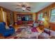 Cozy living room featuring comfortable seating, wood paneling and a decorative rug at 6305 Holly Ridge Rd, Rougemont, NC 27572