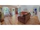 Bright living room with wood floors, a red front door, and cozy seating furniture at 6305 Holly Ridge Rd, Rougemont, NC 27572