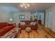 Spacious living room with hardwood floors, couches, and bright lighting at 6305 Holly Ridge Rd, Rougemont, NC 27572