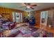 Open living room featuring french doors, brick accent wall, a patterned rug and hardwood floors at 6305 Holly Ridge Rd, Rougemont, NC 27572