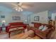 Comfortable living room with hardwood floors, couches, and a ceiling fan at 6305 Holly Ridge Rd, Rougemont, NC 27572