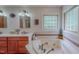 Well-lit bathroom with a jacuzzi tub, tile flooring, and sink with counter space at 6305 Holly Ridge Rd, Rougemont, NC 27572