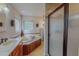 Luxurious bathroom showcasing a jacuzzi tub, glass shower, and dual sinks at 6305 Holly Ridge Rd, Rougemont, NC 27572