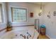 Bathroom showcasing a jacuzzi tub, tile flooring, and bright, natural light at 6305 Holly Ridge Rd, Rougemont, NC 27572