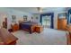 Bright main bedroom with wood furniture, carpeting, and a window with blue curtains at 6305 Holly Ridge Rd, Rougemont, NC 27572