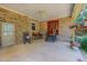 Covered brick patio featuring a fan, seating, and decor overlooking the backyard at 6305 Holly Ridge Rd, Rougemont, NC 27572