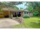 Brick home with covered patio, well-manicured lawn, and lovely landscaping at 6305 Holly Ridge Rd, Rougemont, NC 27572
