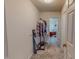 Walk-in closet with carpet and hanging rack leading into bathroom at 6305 Holly Ridge Rd, Rougemont, NC 27572