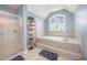 Spacious primary bathroom with large soaking tub and step in shower enclosure at 656 Atkins Rd, Fuquay Varina, NC 27526
