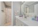 Well-lit bathroom features a large vanity with ample storage and a shower with decorative curtain at 656 Atkins Rd, Fuquay Varina, NC 27526