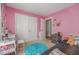 Vibrant pink bedroom with closet, dresser, and comfortable sleeping arrangements at 656 Atkins Rd, Fuquay Varina, NC 27526