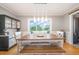 Dining room with wooden table and bench seating, decorative light fixture and large window with a view at 656 Atkins Rd, Fuquay Varina, NC 27526