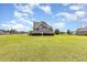 Attractive home with a spacious front yard and healthy grass under a blue, cloudy sky at 656 Atkins Rd, Fuquay Varina, NC 27526
