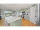 Bright eat-in kitchen featuring stainless appliances, sage colored cabinets, white subway tile backsplash, and wood floors at 656 Atkins Rd, Fuquay Varina, NC 27526