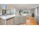 Open concept kitchen with stainless appliances, large island, view to living room, and dining area with a view at 656 Atkins Rd, Fuquay Varina, NC 27526