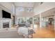 Bright and airy living room with soaring ceilings, a cozy fireplace, and seamless flow to the kitchen at 656 Atkins Rd, Fuquay Varina, NC 27526