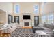 Open-concept living room boasts a fireplace, large windows, and ample space for entertaining guests or Gathering at 656 Atkins Rd, Fuquay Varina, NC 27526