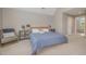 Comfortable main bedroom with decoratively appointed sitting area near the plush queen bed at 656 Atkins Rd, Fuquay Varina, NC 27526