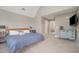 A well lit main bedroom with walk-in closet, access to bathroom, and tasteful decor at 656 Atkins Rd, Fuquay Varina, NC 27526