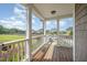 Relax on this covered porch with wooden flooring, offering views of the landscaped yard and neighborhood at 656 Atkins Rd, Fuquay Varina, NC 27526