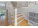 Staircase with wooden stairs, white banister and wood floors at 656 Atkins Rd, Fuquay Varina, NC 27526