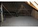 View of the unfinished attic showing wood rafters and some mechanical components at 70 Basil Ct, Franklinton, NC 27525