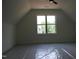 Bonus room with dormer ceiling featuring a large window and new carpet at 70 Basil Ct, Franklinton, NC 27525