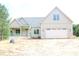 Charming new construction with a two-car garage and front porch, perfect for enjoying the outdoors at 70 Basil Ct, Franklinton, NC 27525