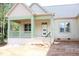 Inviting front porch with brick base and green trim, perfect for relaxing and enjoying the view at 70 Basil Ct, Franklinton, NC 27525