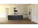 Bright kitchen featuring an island with bar seating, stainless appliances, and ample counter space at 70 Basil Ct, Franklinton, NC 27525