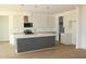 Modern kitchen with a large island, stainless steel appliances, and pendant lighting fixtures at 70 Basil Ct, Franklinton, NC 27525