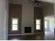 Living room with high ceilings, a fireplace, and large windows offering plenty of natural light at 70 Basil Ct, Franklinton, NC 27525