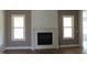 Cozy living room featuring a fireplace, large windows, and neutral wall paint at 70 Basil Ct, Franklinton, NC 27525