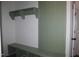 View of the mudroom with built-in bench, shelving and green accent wall with vertical stripes at 70 Basil Ct, Franklinton, NC 27525